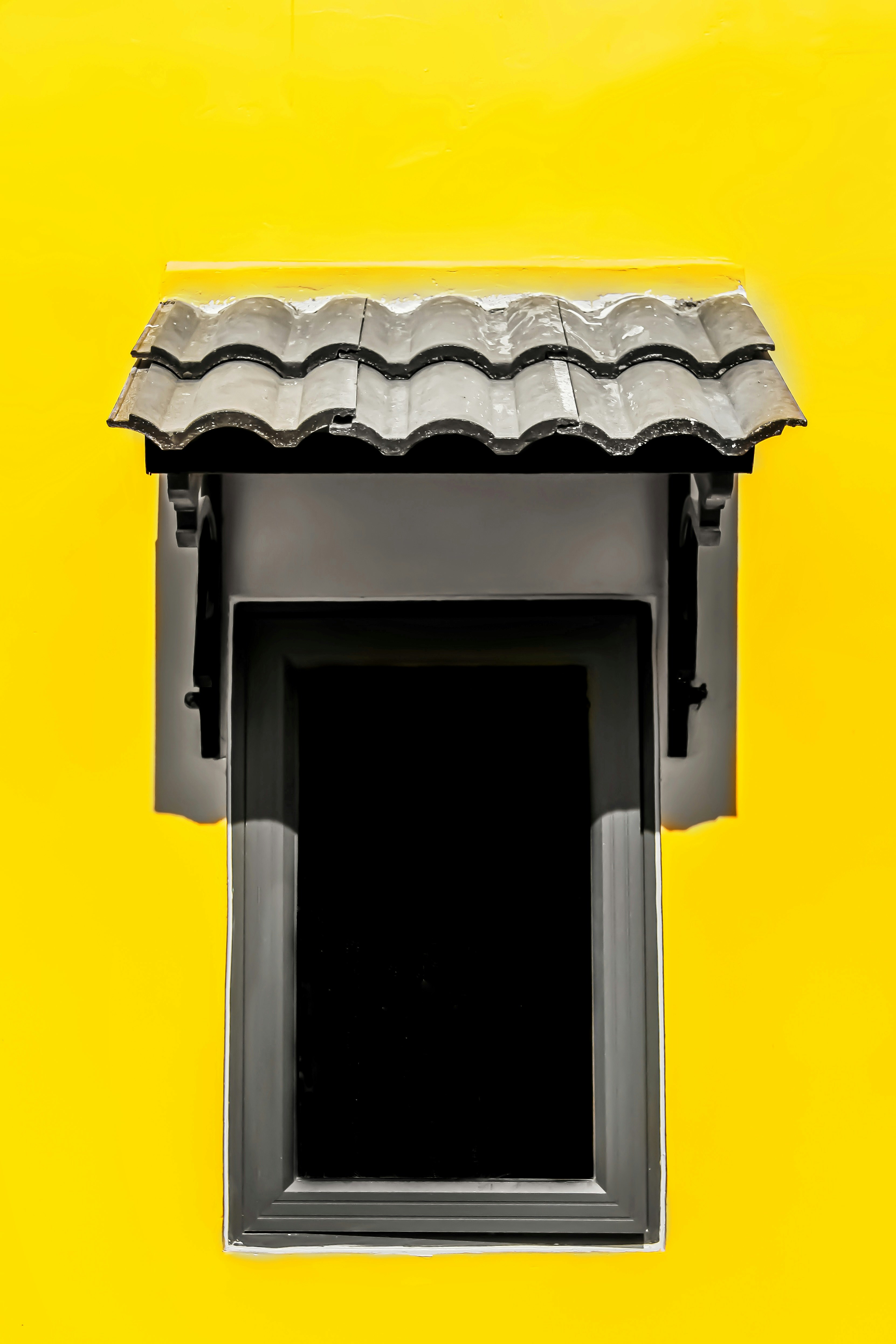 black wooden door with yellow wall